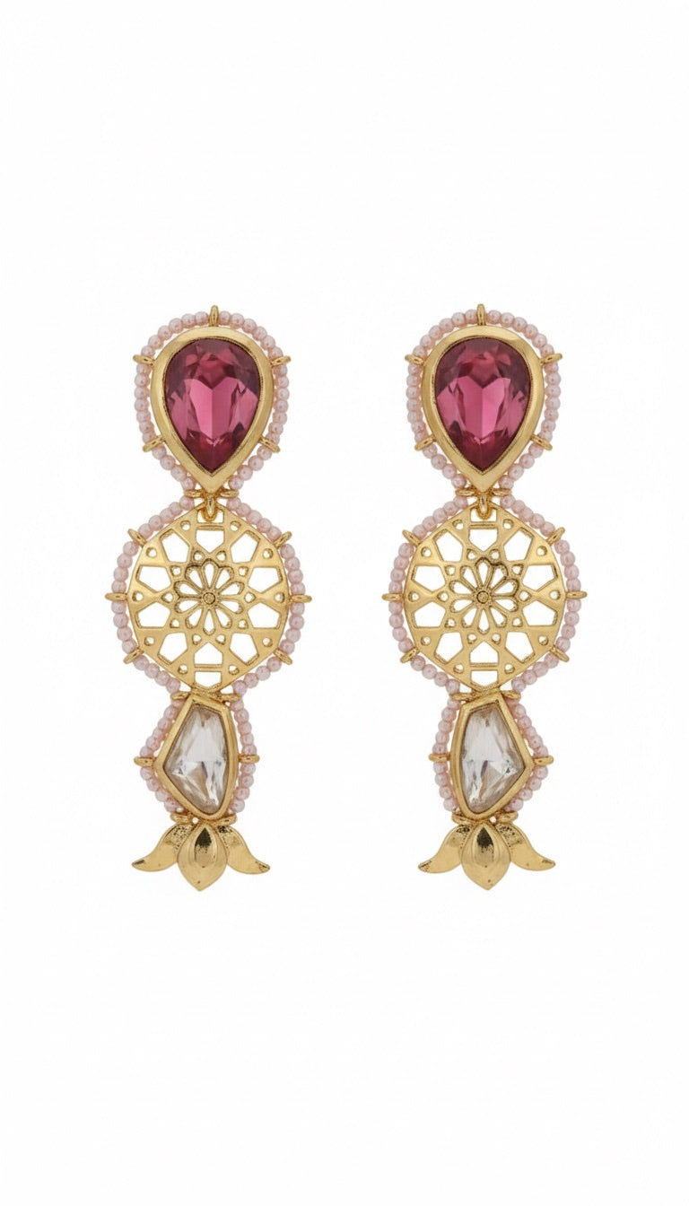 Gold earrings with red gemstones on a white background