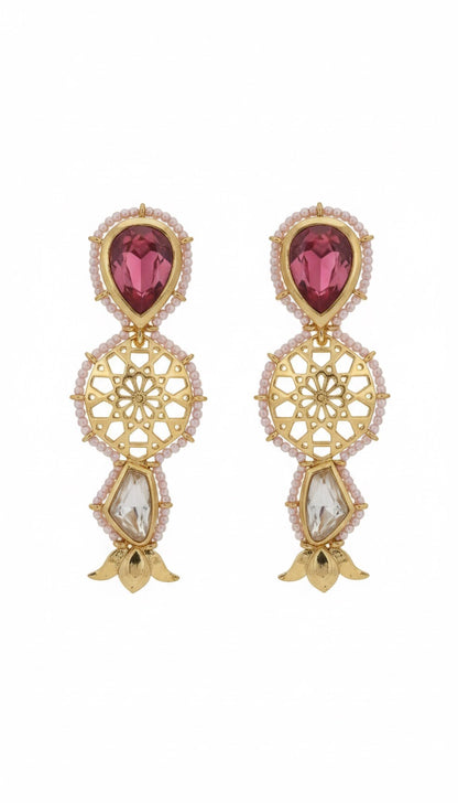 Gold earrings with red gemstones on a white background
