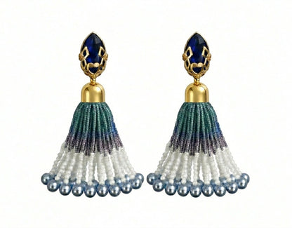 Pair of tassel earrings with blue and gold accents on a white background