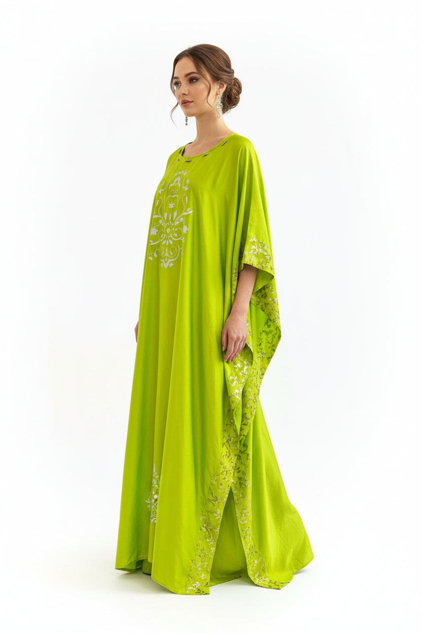 Woman wearing a bright green dress with floral patterns on a white background