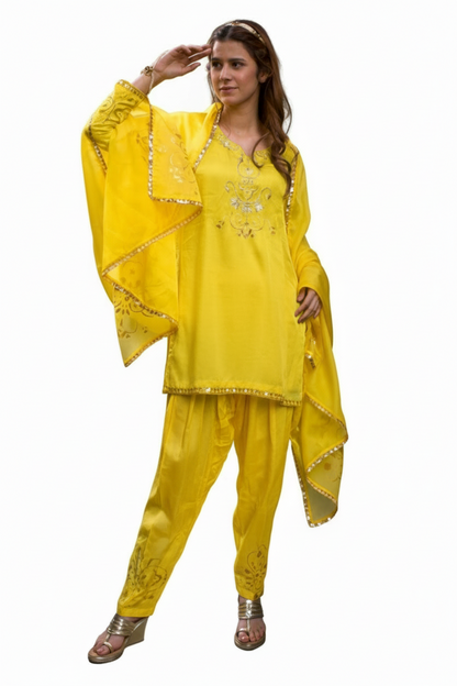 Woman wearing a yellow traditional outfit with a dupatta on a white background