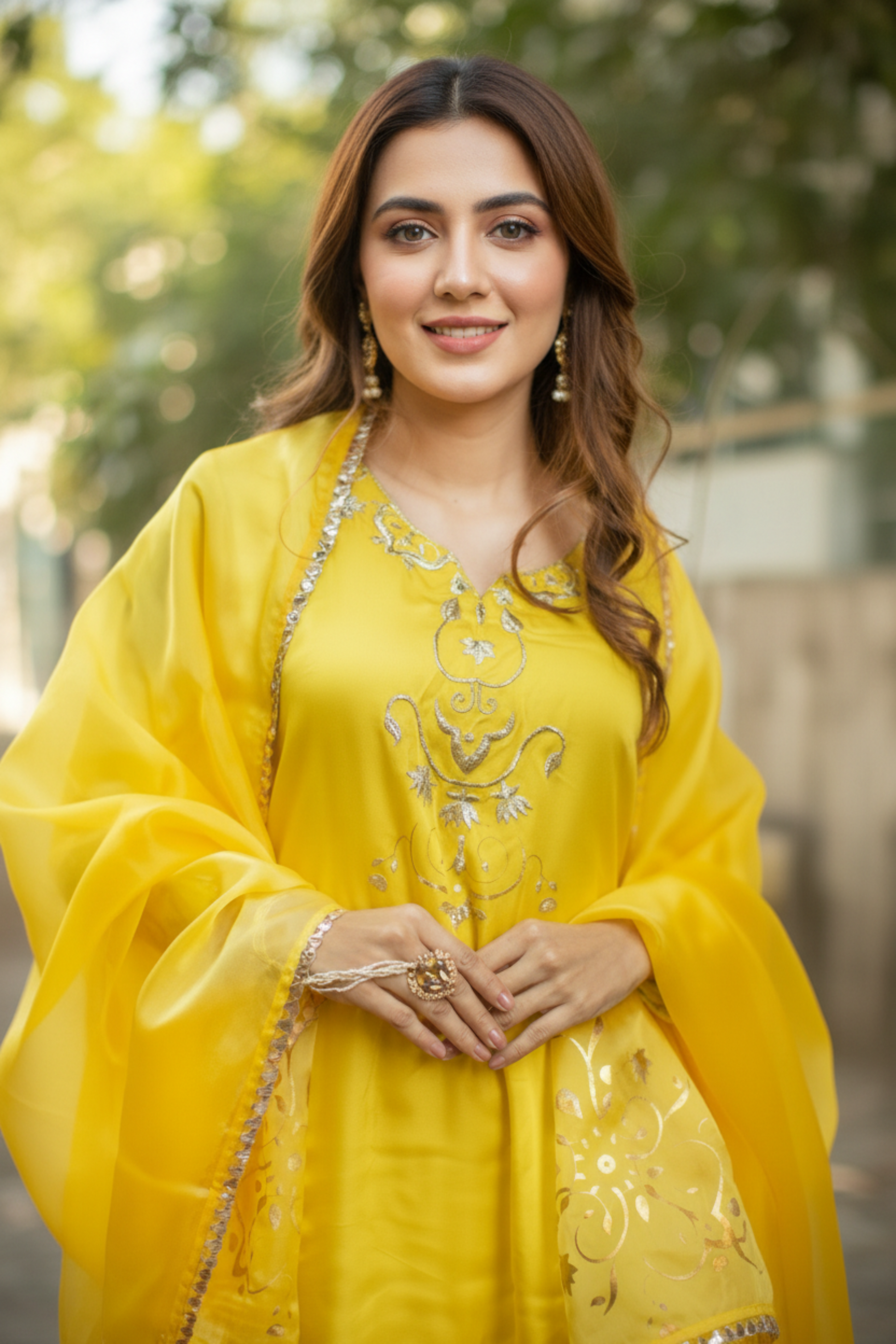 Person wearing a yellow traditional outfit with intricate designs